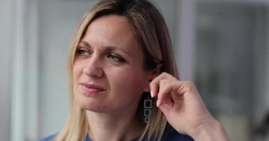 Woman scratching inside of ear with finger 4k movie slow motion. Itchy ears concept