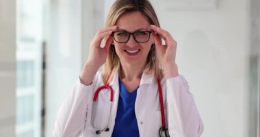 Smiling woman doctor taking off vision glasses portrait 4k movie slow motion. Doctor career concept