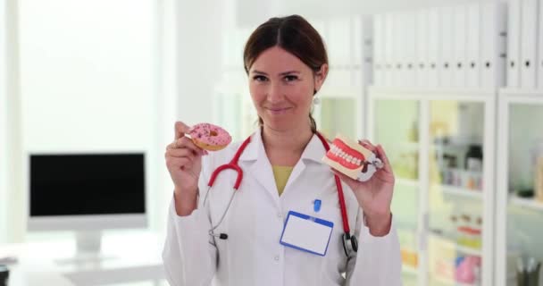 Doctor Holding Model Jaws Teeth Sweet Donut Movie Slow Motion — Video Stock