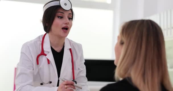 Ent Doctor Head Reflector Examining Patient Throat Using Flashlight Movie — Vídeo de Stock