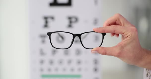 Doctor Ophthalmologist Holding Glasses Background Table Vision Test Closeup Movie — Vídeos de Stock