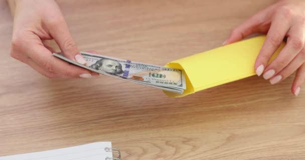 Employer Hands Putting Money Dollar Bills Yellow Envelope Closeup Movie — Wideo stockowe