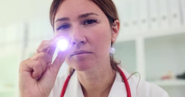 Doctor Looks Stethoscope Shines Flashlight Camera Neurologist Ophthalmologist Eye Examination — Stock Video