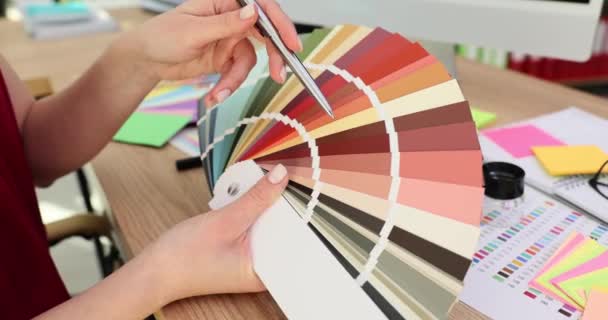 女性デザイナーの手が多色のパレットサンプルに触れます インテリアの色を選択する — ストック動画