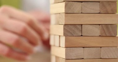 Tahta Jenga oyununda el ele tutuşmak. Ticari risk kavramı