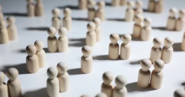 Ahşap kadın ve erkek heykelcikleri ve yalnız bir siluet. Aile ve ilişkiler yaratma sorunu