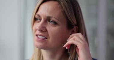 Ağır çekimde tahriş olmuş bir kadın kulağını kaşır. Kadının kaşındıran kulakçık derisi. Egzama ve işitme sorunlarının semptomları