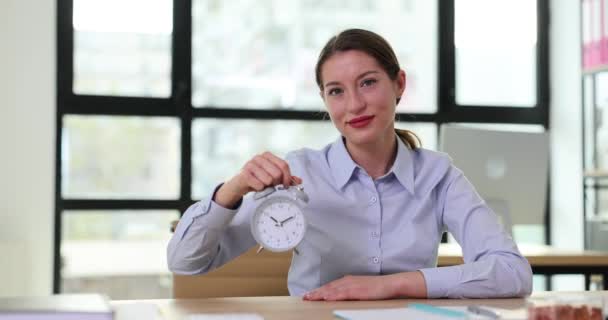笑顔のビジネス女性は 午前10時に目覚まし時計を手に持っています スケジュールと作業時間 — ストック動画