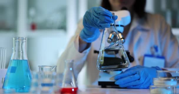 Lab Technician Stirs Liquid Beaker Circular Motions Researcher Rubber Gloves — Stock Video