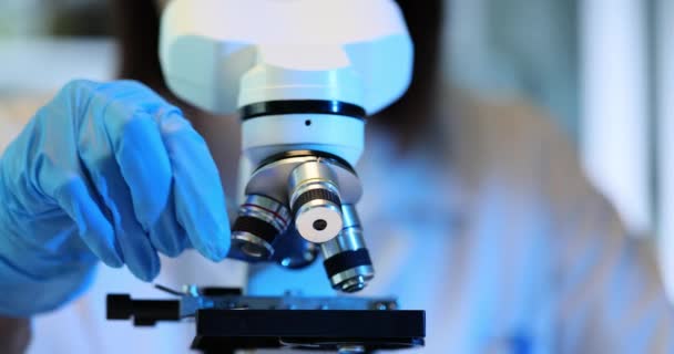 Competent Scientist Scrutinizes Specimen Using Microscope Researcher Uses Various Microscope — Stock Video