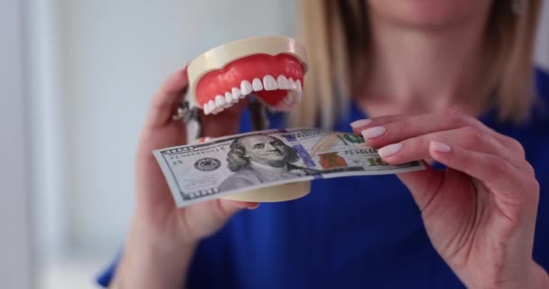 Woman Dentist Places Hundred Dollar Banknote Jaw Model Standing Office — Stock Video