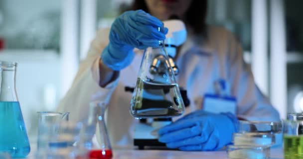 Scientist Carefully Examines Transparent Liquid Conical Flask Laboratory Toxic Solvent — Stock Video