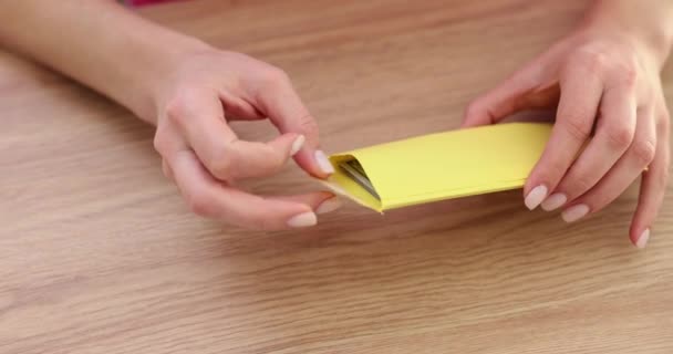 女性は黄色い封筒を開け 100枚の請求書を取り出します 封筒にブライブオファーと給料 — ストック動画