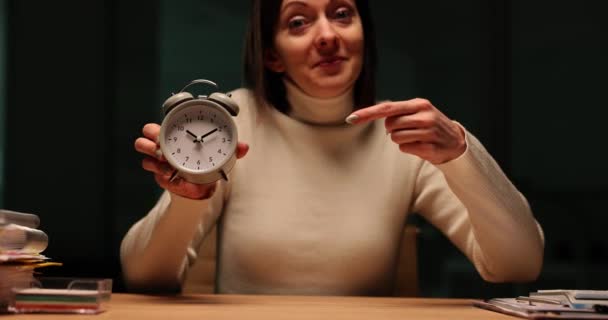Woman Sits Desk Holding Vintage Alarm Clock Slow Motion Overworked — Stock Video