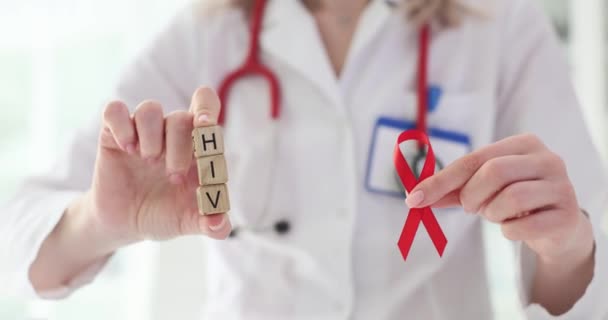 Doctor Holding Red Ribbon Wooden Blocks Word Hiv Closeup — Stock Video