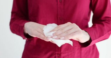 Woman wipes hands with disposable napkin. Hand hygiene and cleanliness