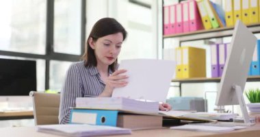 Focused office worker checking documents efficiently. Woman manager secretary working with business documentation in the office