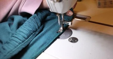 Process of sewing trouser belts on sewing machine. Sewing services on a sewing machine