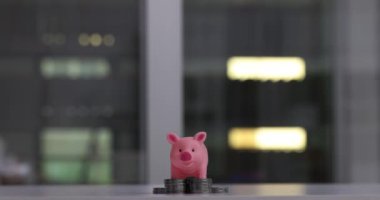 Pink piggy bank on a stack of growing silver coins. Increased profits and profitable cash investments