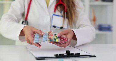 Klinikte elinde bir sürü hap tutan bir doktor. İlaç alma kuralları