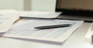 Hesapları ve kalemi olan önemli bir belge büroda duruyor. Mali raporlar ve bütçe raporları ayrıntılı analiz için hazırlanmıştır.