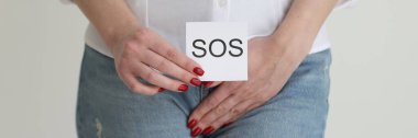 Woman covers groin with hand and shows message SOS in studio. Lady suffers from strong pain in genital area. Symptoms of inflammation clipart