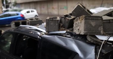 Şehir caddesine düşen enkaz yüzünden araba hasar gördü. Her leke, yolda karşılaşılan zorlukları yansıtan araba yolculuğunun hikayesini anlatıyor.