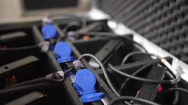 Erkek, ses mühendisi, kabloları siyah bir çantaya koyuyor..