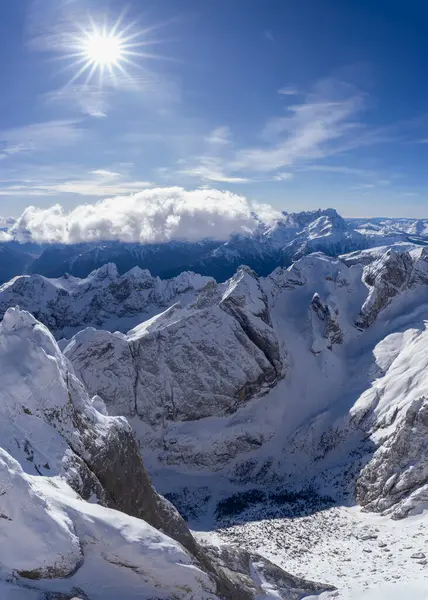 Capture the serene atmosphere of Marmolada Mountains snow-covered peaks under a bright sun. Image, taken from the aerial tramway building, highlights the mountains intricate details and contours
