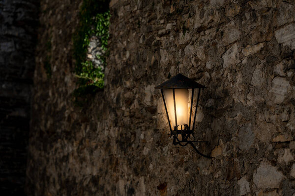 Old lamp at the wall of an old building