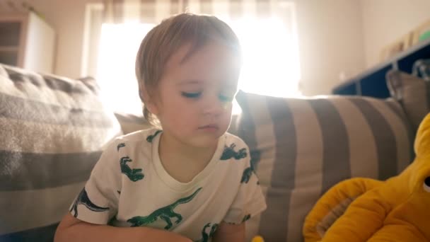 Маленький Хлопчик Зручно Сидить Дивані Захоплений Читанням Книги Вправами Ручкою — стокове відео