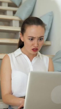 Genç bir kadın, kötü haber aldıktan sonra bilgisayarla iş arkadaşıyla konuşuyor. Sinirli bayan merdivenlerde oturur ve kameraya dikey döner..