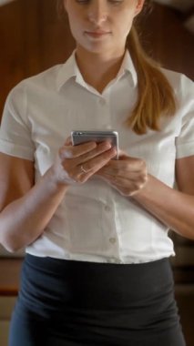 İş kadınlarının özel jet uçuşu telefonda iş hakkında konuşuyor. Önemli bir iş anlaşması için arkadaşıyla cep telefonundan aradı. 4k Ultra HD dikey çekim.