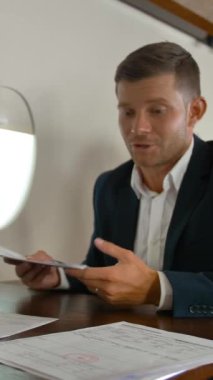 İki yakışıklı iş adamı, erkek ve kadın, modern lüks özel jetin içinde büyük bir iş anlaşması imzalıyorlar. Orta yavaş çekimde bebek çekimi. 4k Ultra HD. Dikey çekim.