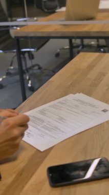 Müşteri toplantı sırasında ofiste iş sözleşmesi imzalıyor. Toplantı odasında ciddi tartışmalar ve önemli belgelerin imzalanması var. 4k Ağır çekim. Dikey çekim.