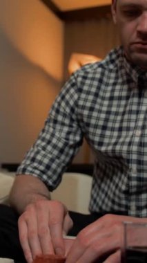 Erkek, poker fişlerini ev partisi kumar oyununda her şeye yatırır. Dikey çekim.