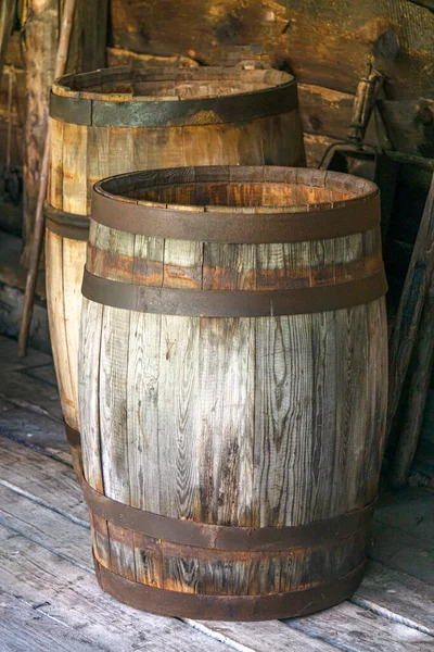 Old wooden barrels with iron rims for food storage