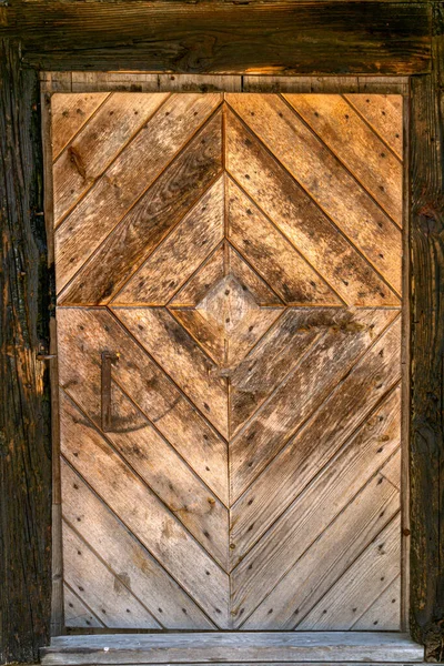 An old homemade massive wooden door, a fragment of an old estate