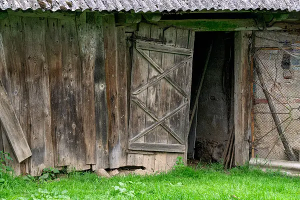 Vintage broken wooden barn door made from boards