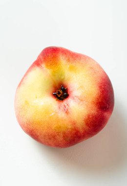 ripe and fresh flat peach on a white background. harvest. fruit shop