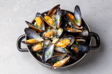 Delicious seafood mussels with parsley sauce and lemon. Delicious steamed mussels.