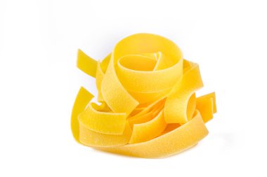 Homemade egg pasta tagliatelle. Raw nest noodles, uncooked ribbon fettuccine, dry long rolled macaroni isolated on white background top view
