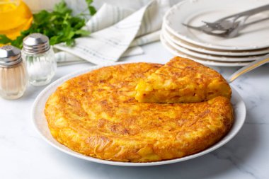 Spanish omelette with potatoes, typical spanish cuisine on gray concrete floor. Tortilla Espanola. Turkish name; Yumurtali patates