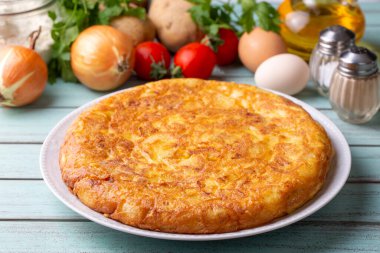 Spanish omelette with potatoes, typical spanish cuisine on gray concrete floor. Tortilla Espanola. Turkish name; Yumurtali patates