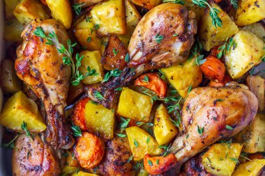 Baked chicken thighs and fried potatoes look delicious.