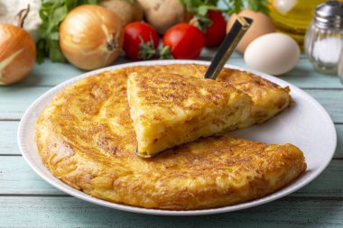 Spanish omelette with potatoes, typical spanish cuisine on gray concrete floor. Tortilla Espanola. Turkish name; Yumurtali patates