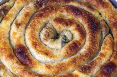 Traditional Turkish pastry with spinach. (Turkish Name: Ispanakli Kol Boregi, Bosnak boregi). Handmade pastry with spinach filling.