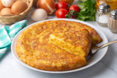 Spanish omelette with potatoes, typical spanish cuisine on gray concrete floor. Tortilla Espanola. Turkish name; Yumurtali patates