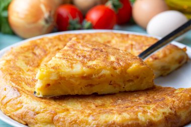 Spanish omelette with potatoes, typical spanish cuisine on gray concrete floor. Tortilla Espanola. Turkish name; Yumurtali patates