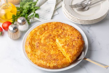 Spanish omelette with potatoes, typical spanish cuisine on gray concrete floor. Tortilla Espanola. Turkish name; Yumurtali patates